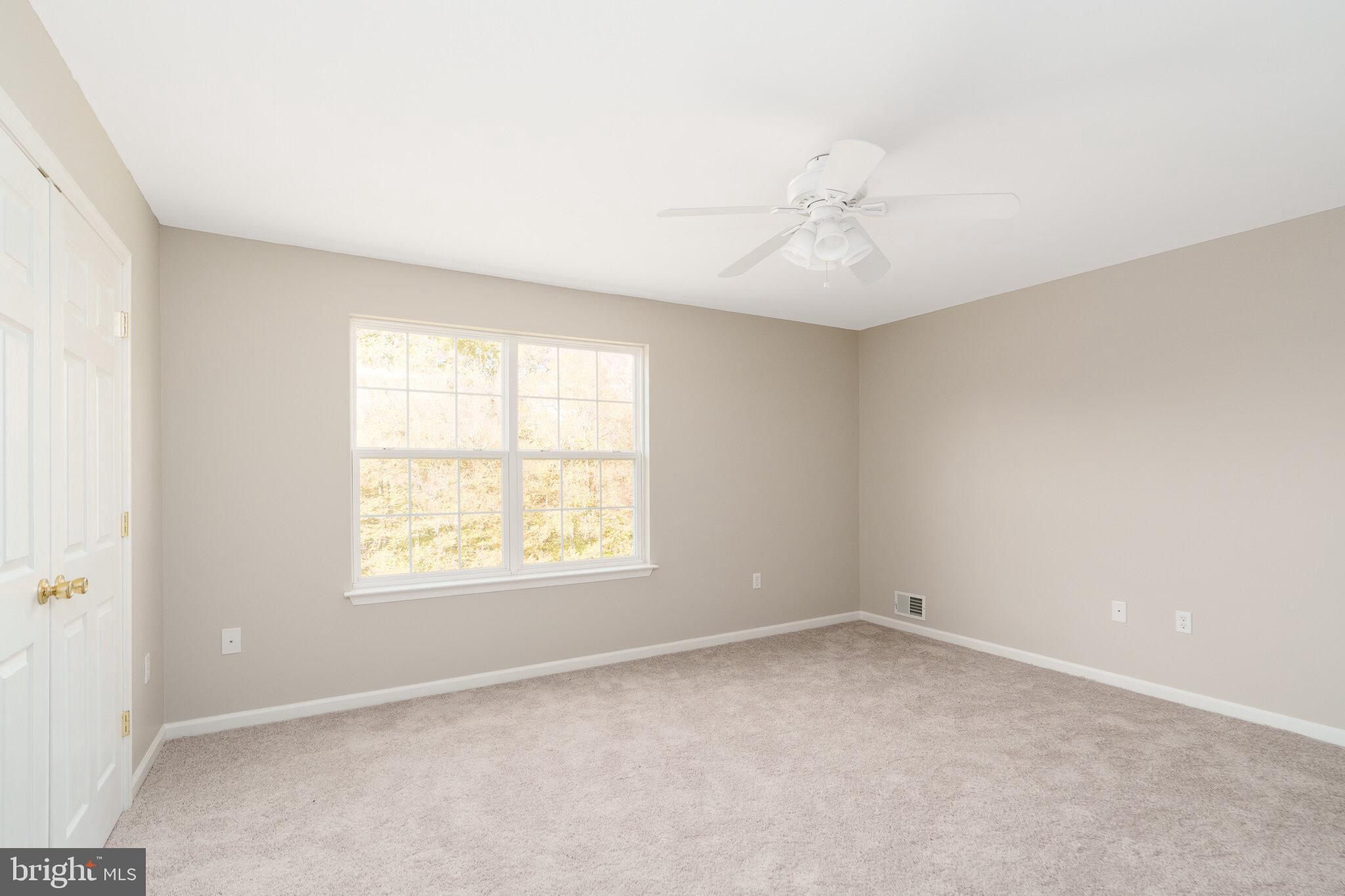 112 Ben Boulevard Elkton, MD 21921 - Photo 13 of 22 an empty room with a window and a ceiling fan