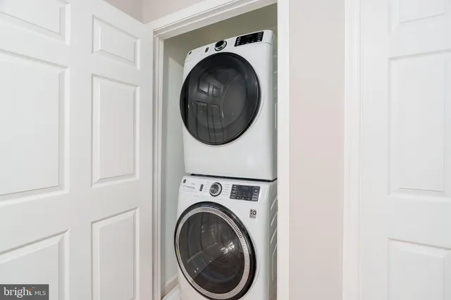 a view of a hallway with washer and dryer