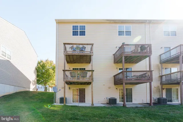 a view of a house with many windows and a yard