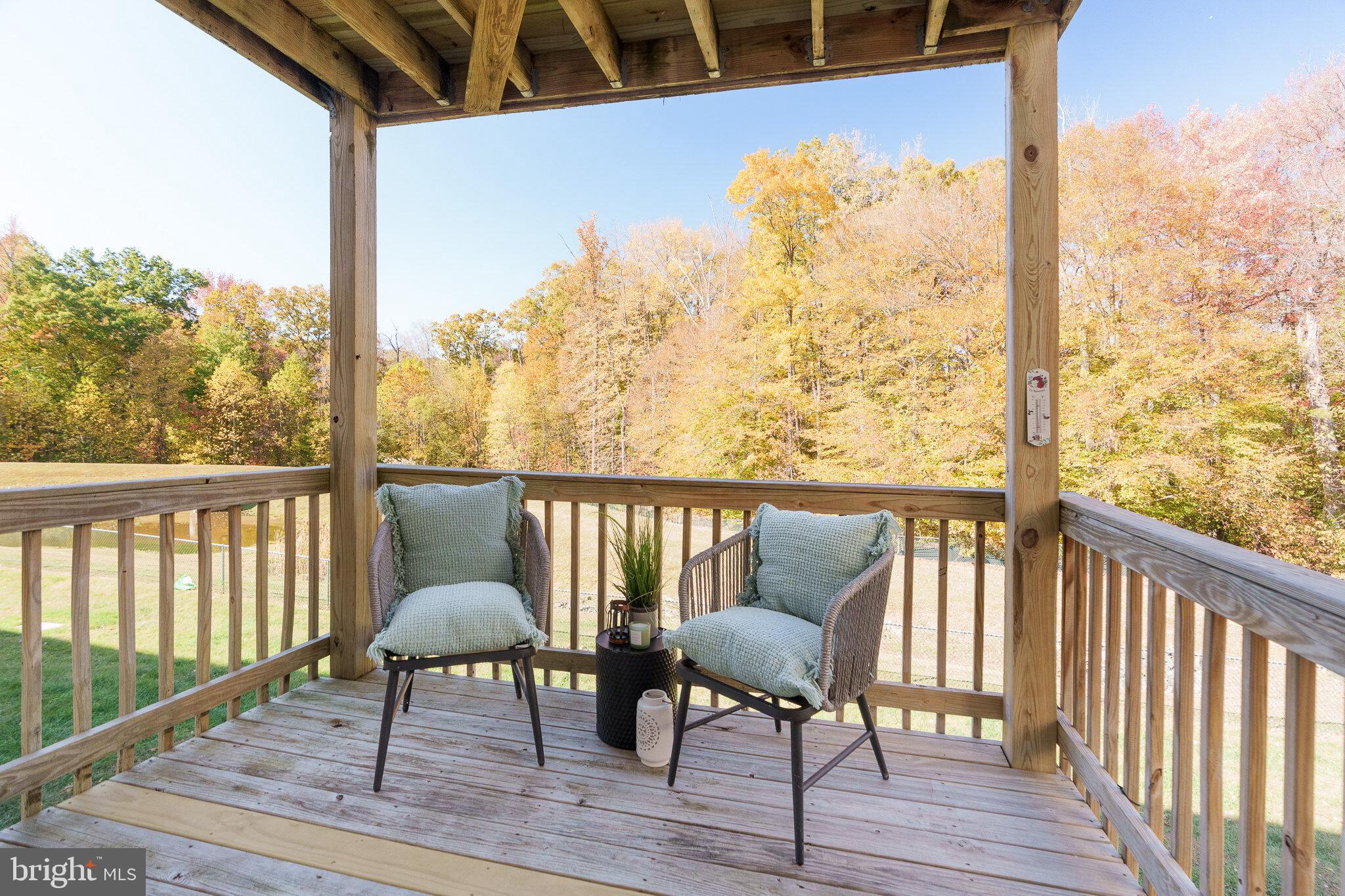 112 Ben Boulevard Elkton, MD 21921 - Photo 5 of 22 a view of a balcony with chairs and wooden floor