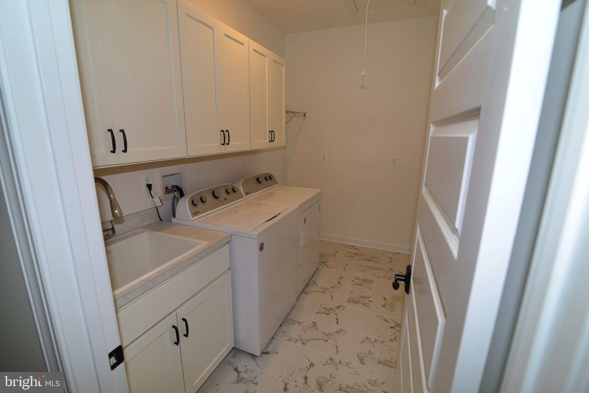 8700 Green Valley Road Union Bridge, MD 21791 - Photo 19 of 40 Main level Laundry has sink, storage, & coat rack.