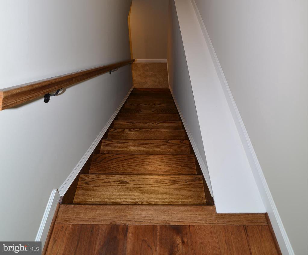 8700 Green Valley Road Union Bridge, MD 21791 - Photo 21 of 40 Hardwood stairs lead to finished basement.