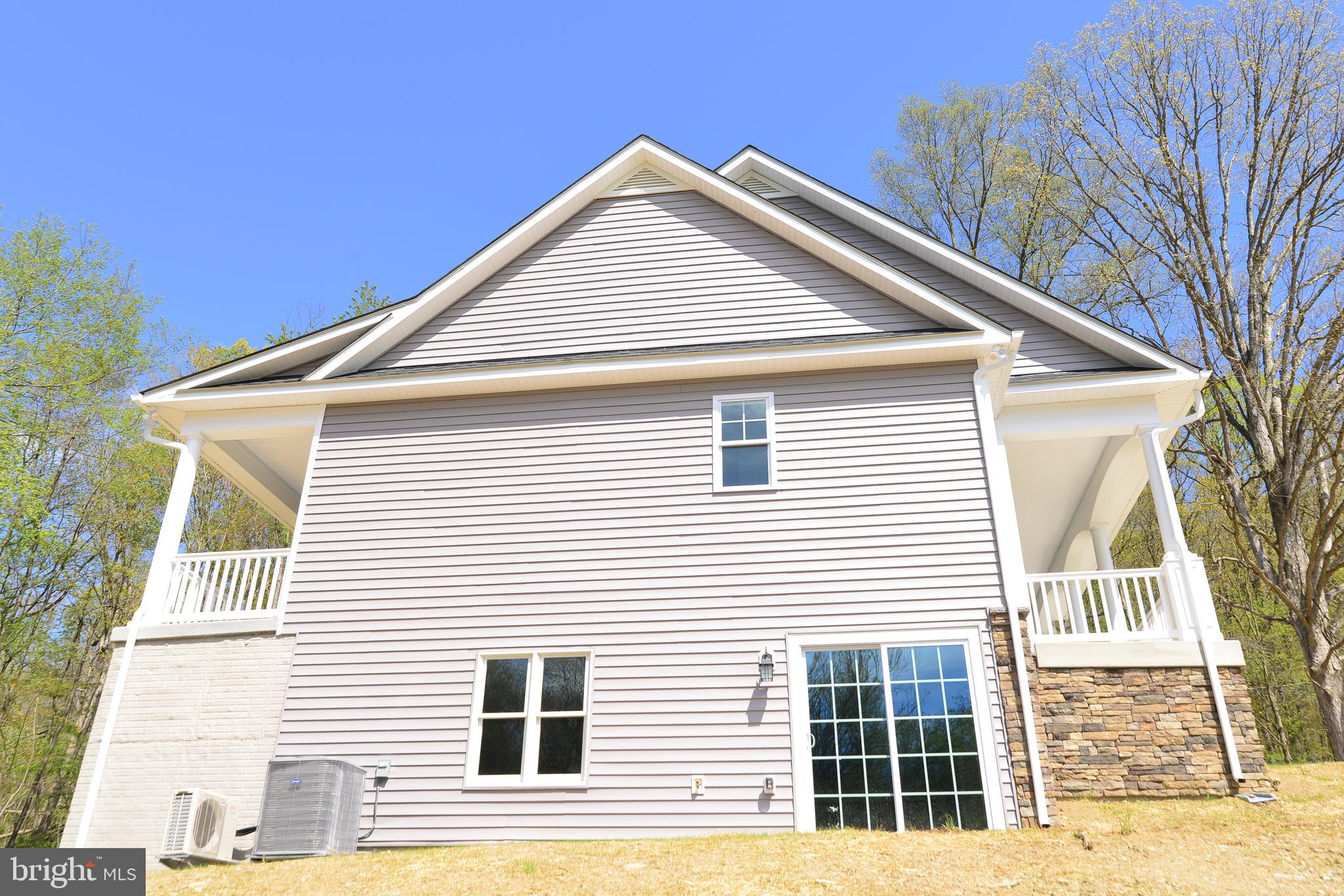 8700 Green Valley Road Union Bridge, MD 21791 - Photo 34 of 40 Side view of home, doors lead into basement.