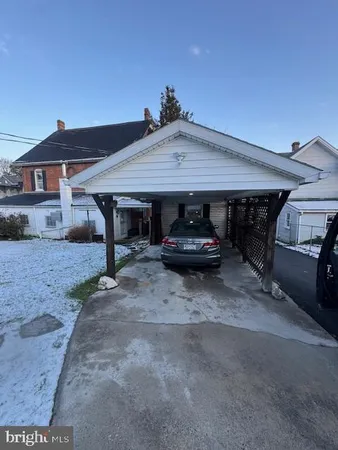 a view of a car parked in front of house