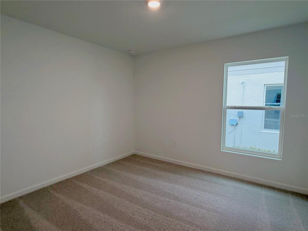 2154 Lasso Loop Eagle Lake, FL 33839 - Photo 13 of 32 an empty room with a window