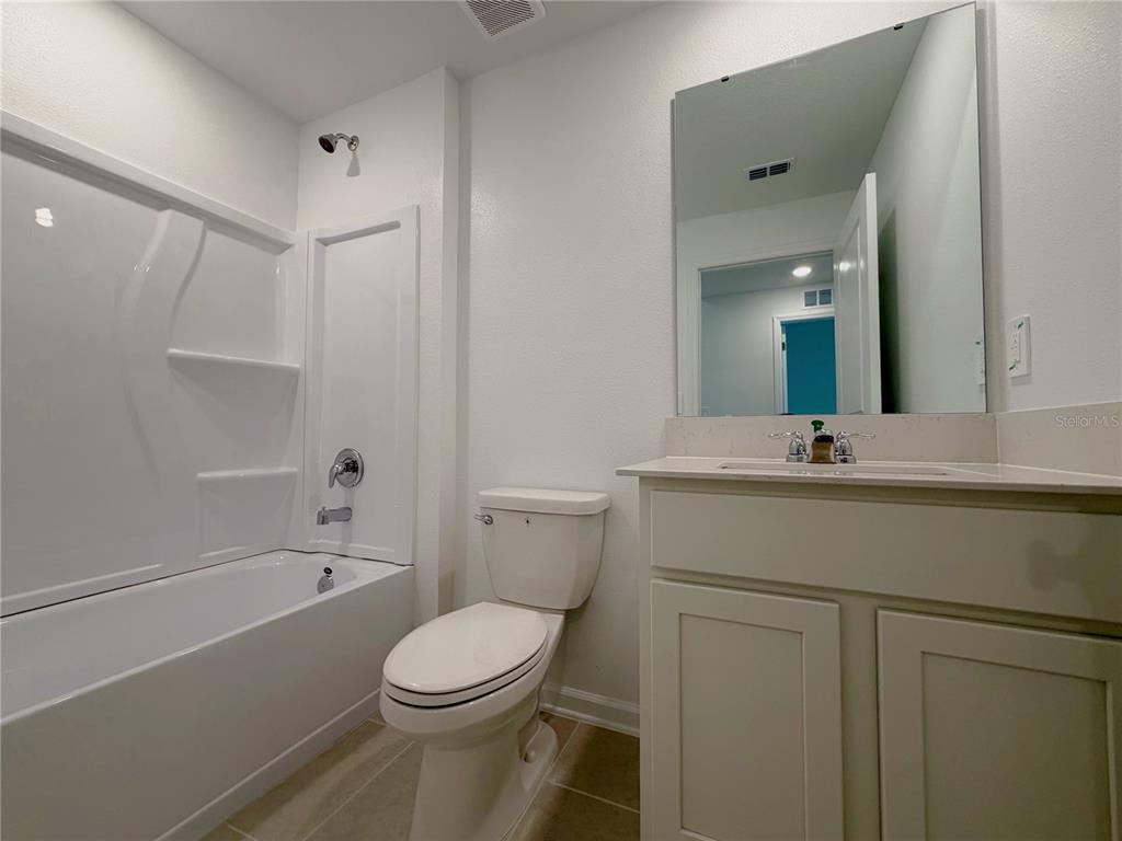 2154 Lasso Loop Eagle Lake, FL 33839 - Photo 14 of 32 a bathroom with a sink a toilet and shower