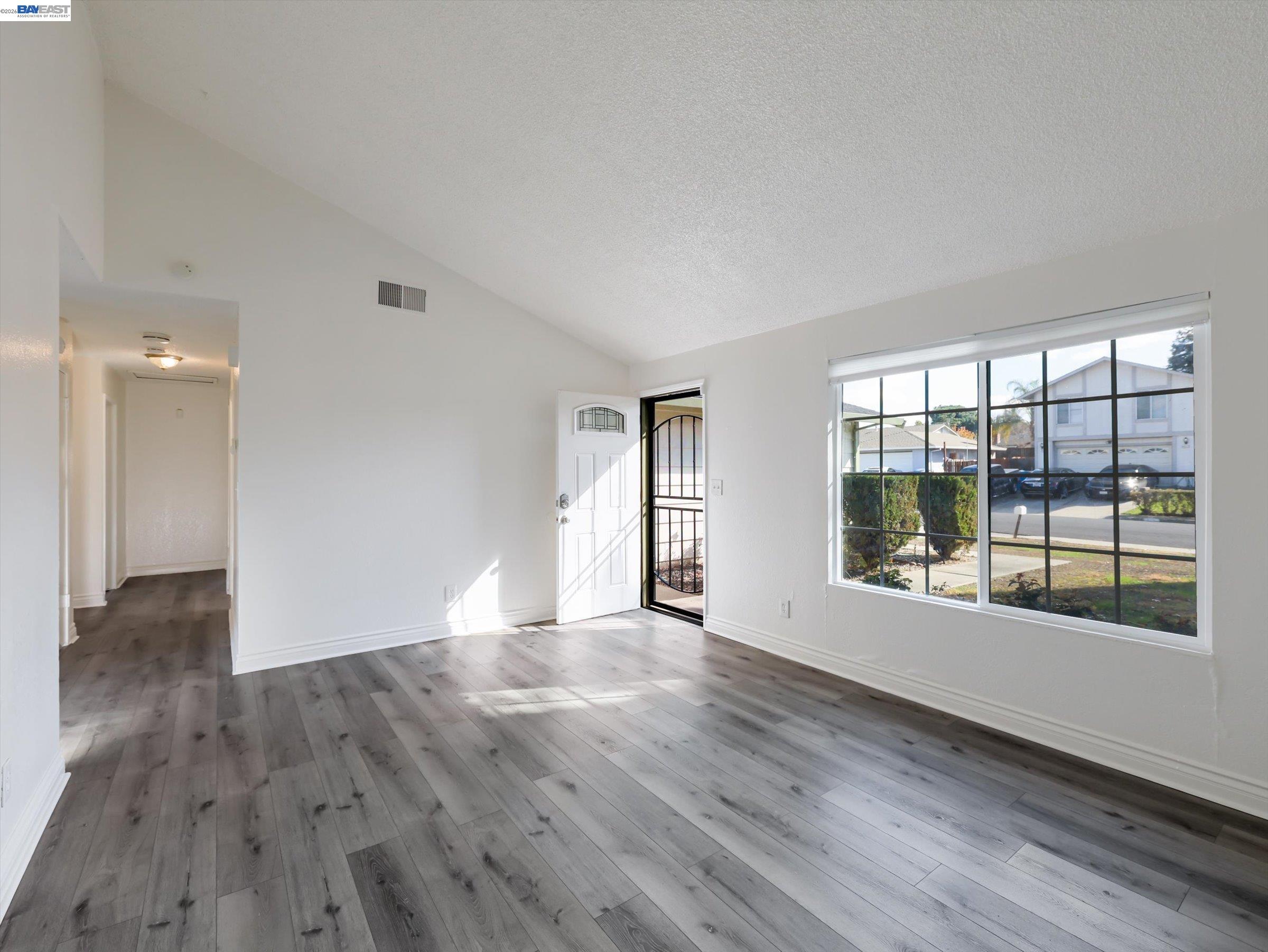3432 Danielle Place Bay Point, CA 94565 - Photo 7 of 36 a view of an empty room with wooden floor and a window