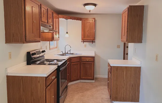 a kitchen with stainless steel appliances a sink stove and cabinets