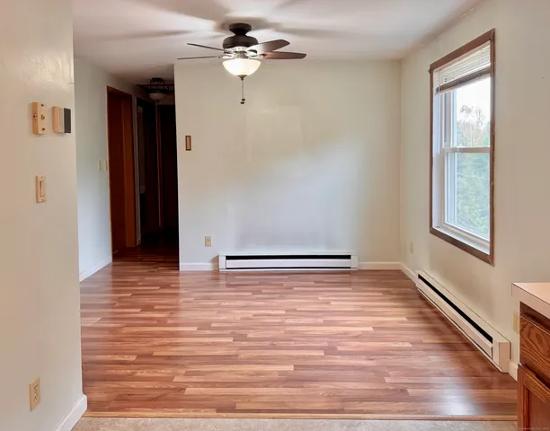 a view of room with window and wooden floor