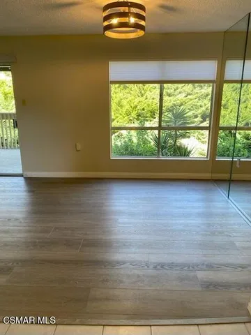 a view of a room with wooden floor and a window