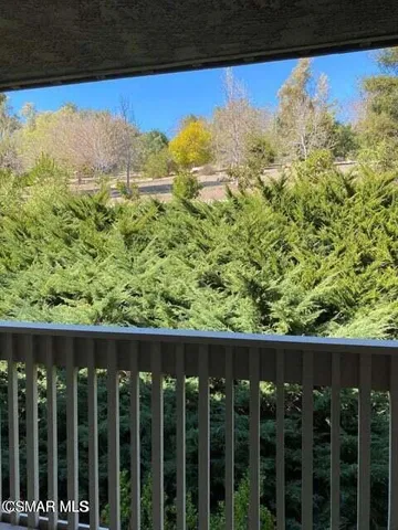 a view of a balcony with wooden fence