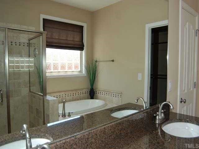 6227 Oconner Street Raleigh, NC 27617 - Photo 5 of 11 a bathroom with a sink and a mirror