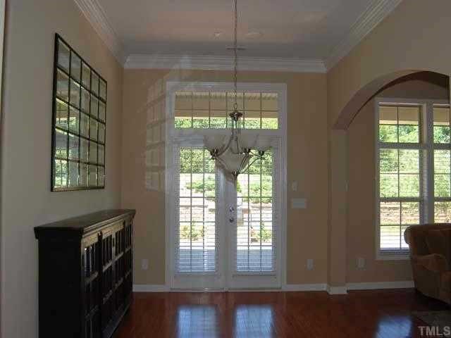 6227 Oconner Street Raleigh, NC 27617 - Photo 8 of 11 a view of an empty room with a window and wooden floor
