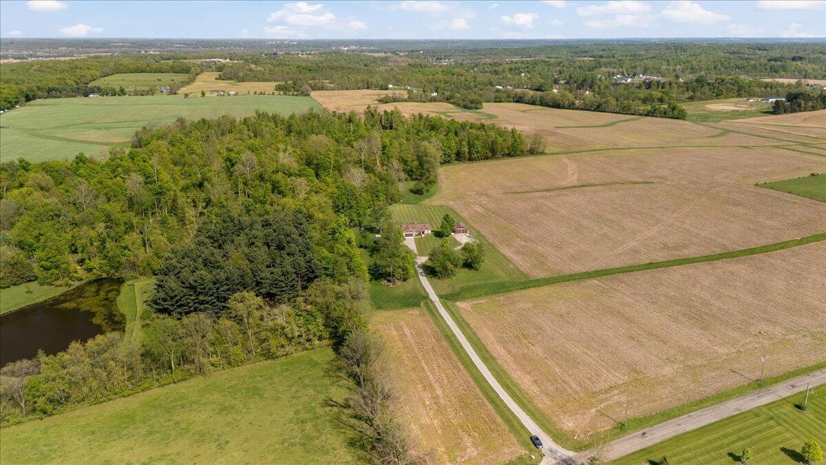 Aerial View- Farmed area in front yard going up drive is a part of the property