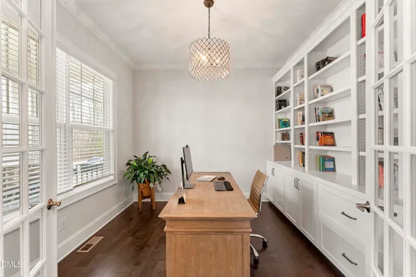 a kitchen with granite countertop white cabinets and stainless steel appliances