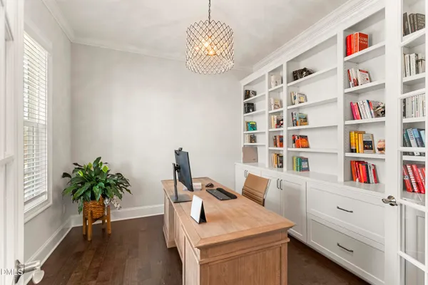 a kitchen with stainless steel appliances kitchen island granite countertop a stove a sink a refrigerator and white cabinets with wooden floor