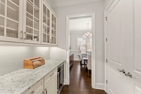 a dining room with furniture a chandelier and wooden floor