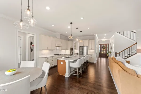 a view of a hallway with wooden floor and closet