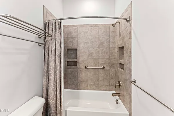 a en suite bathroom with a double vanity sink and a mirror