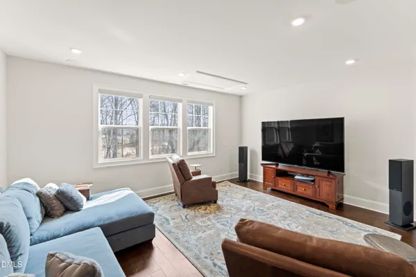 a view of a a dining room with furniture window and wooden floor