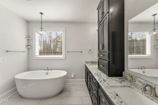 a view of a patio with two couches and deck with wooden floor and fence