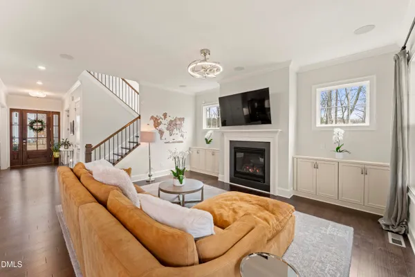 a living room with furniture a flat screen tv and a fireplace