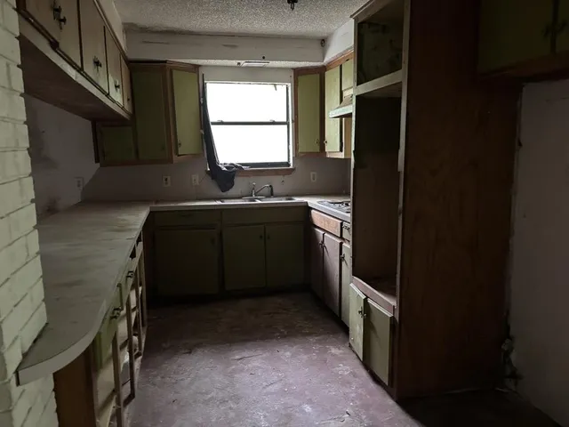 a kitchen with a sink and a refrigerator