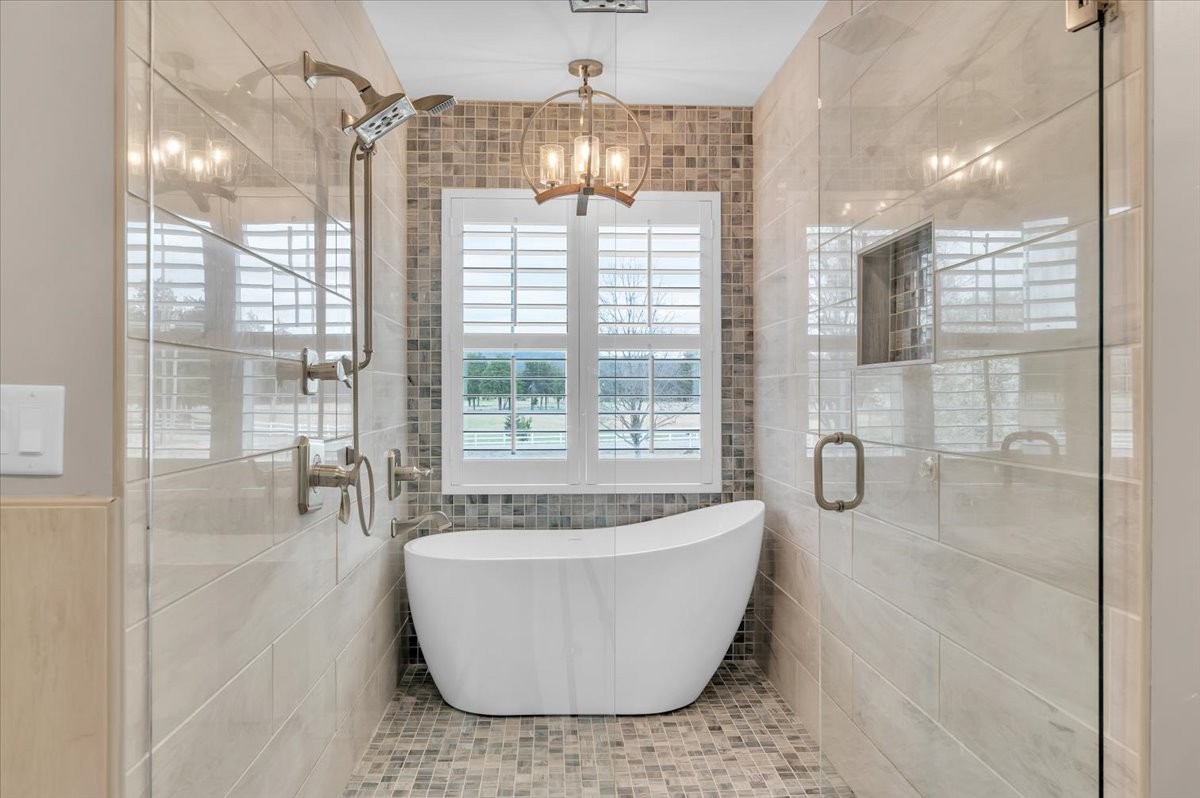 310 Edd Joyce Road Bell Buckle, TN 37020 - Photo 14 of 67 a spacious bathroom with a bathtub and chandelier