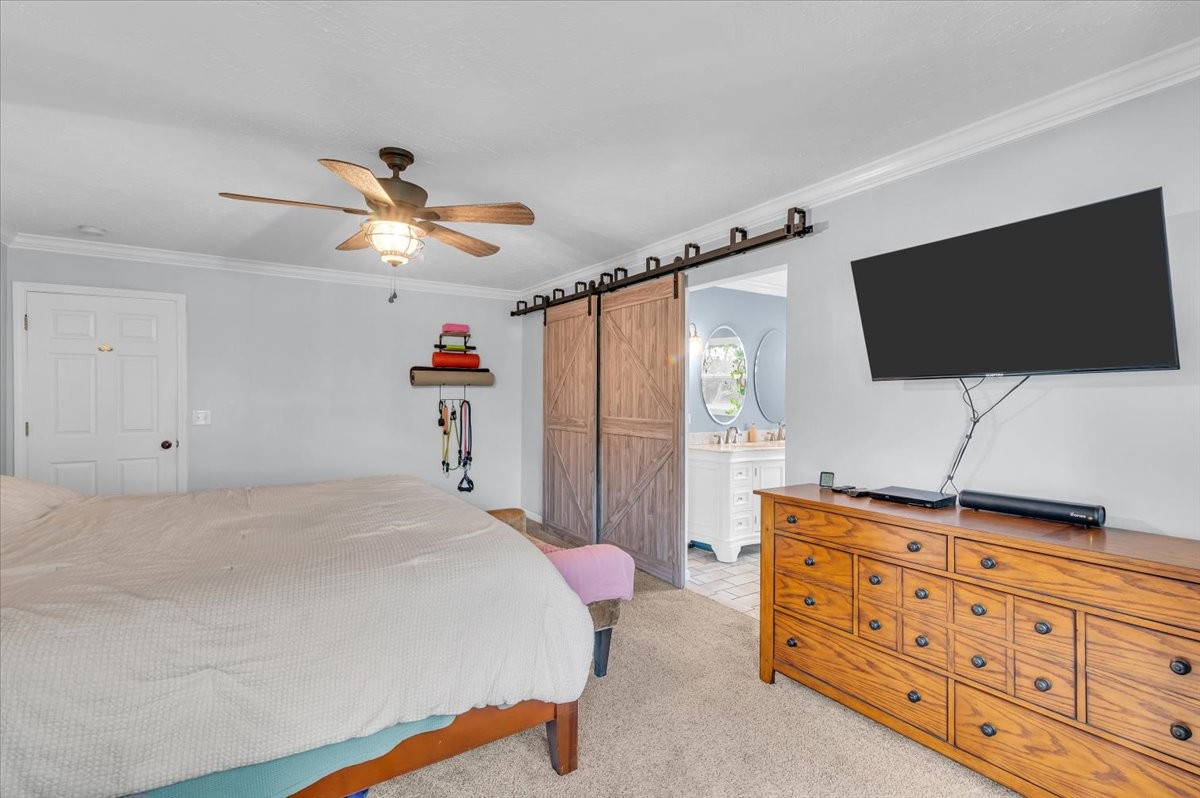 310 Edd Joyce Road Bell Buckle, TN 37020 - Photo 15 of 67 a bedroom with a bed and a flat screen tv