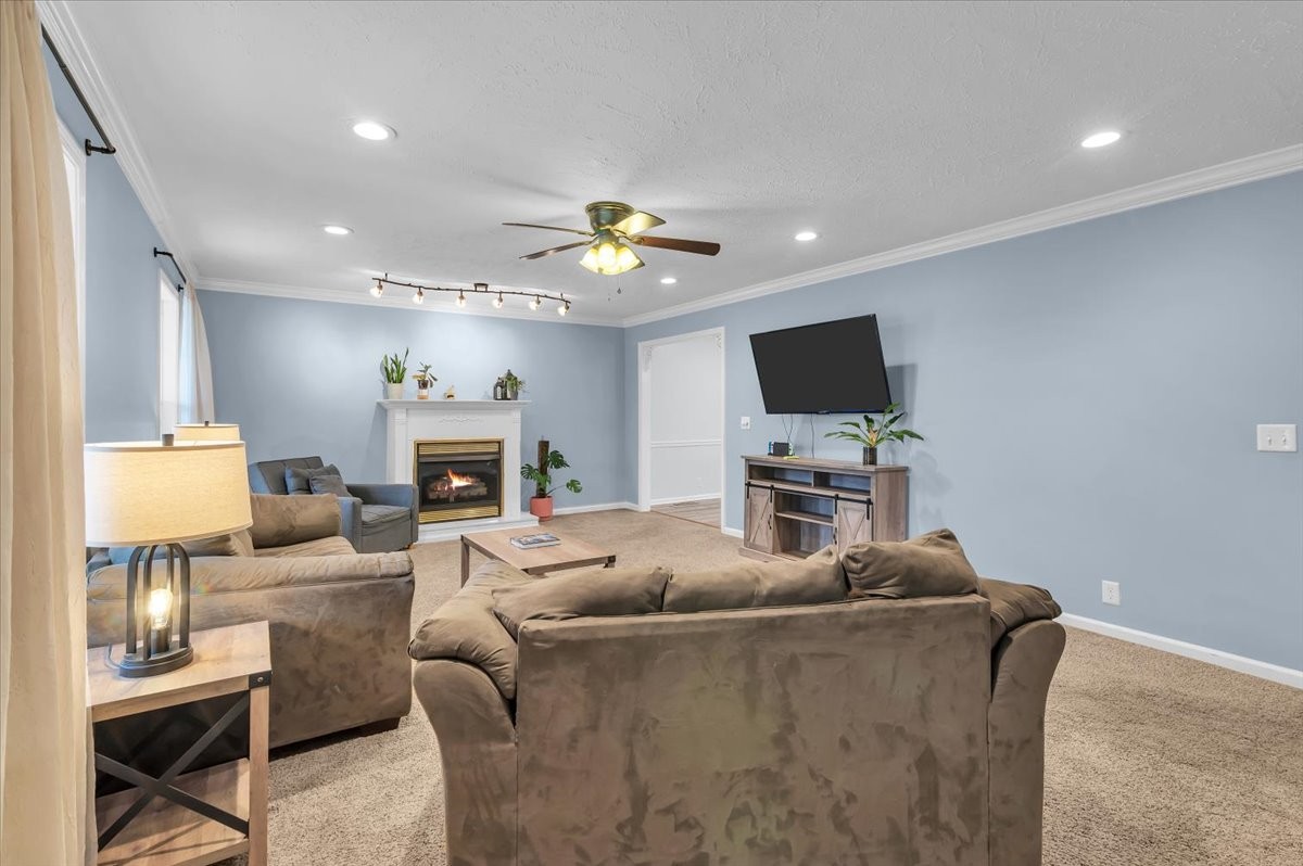 310 Edd Joyce Road Bell Buckle, TN 37020 - Photo 21 of 67 a living room with furniture a fireplace and a flat screen tv