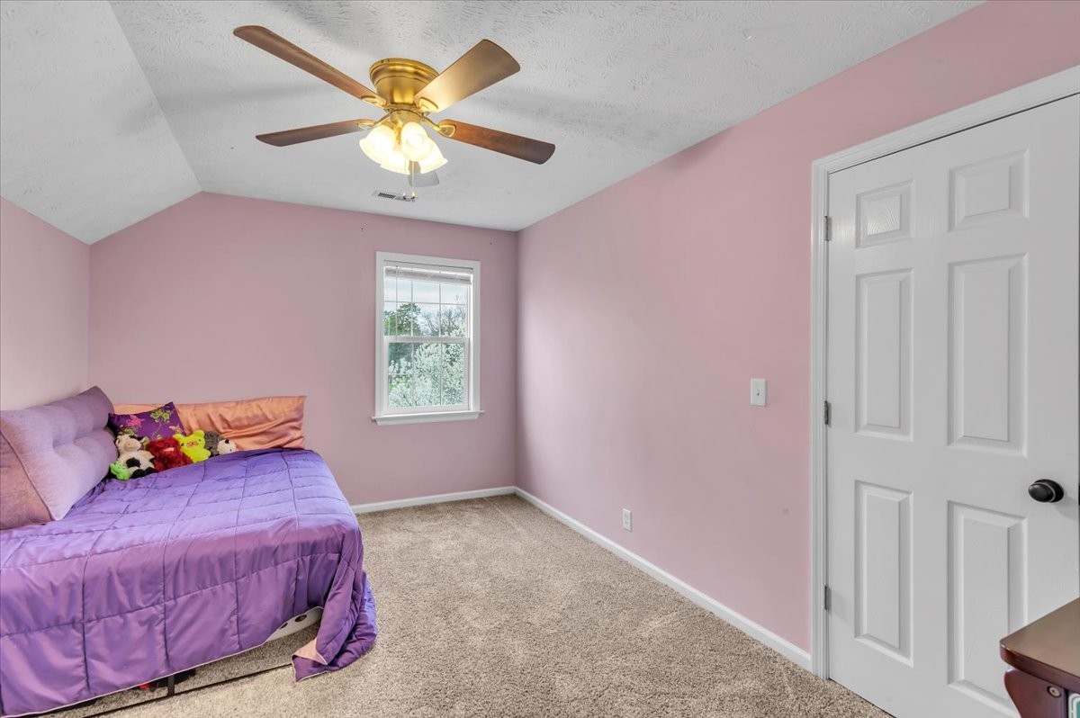 310 Edd Joyce Road Bell Buckle, TN 37020 - Photo 31 of 67 a bedroom with a bed and a chandelier