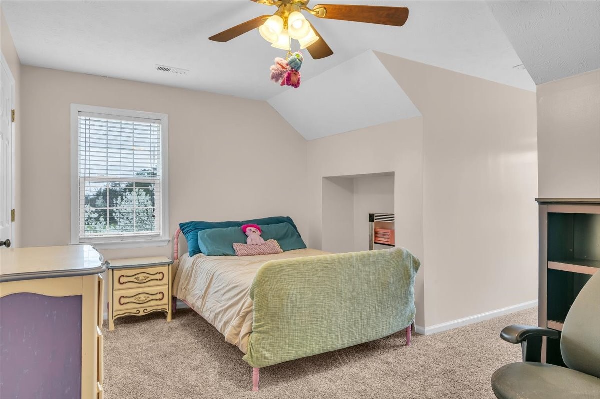 310 Edd Joyce Road Bell Buckle, TN 37020 - Photo 32 of 67 a bedroom with a bed and a chandelier