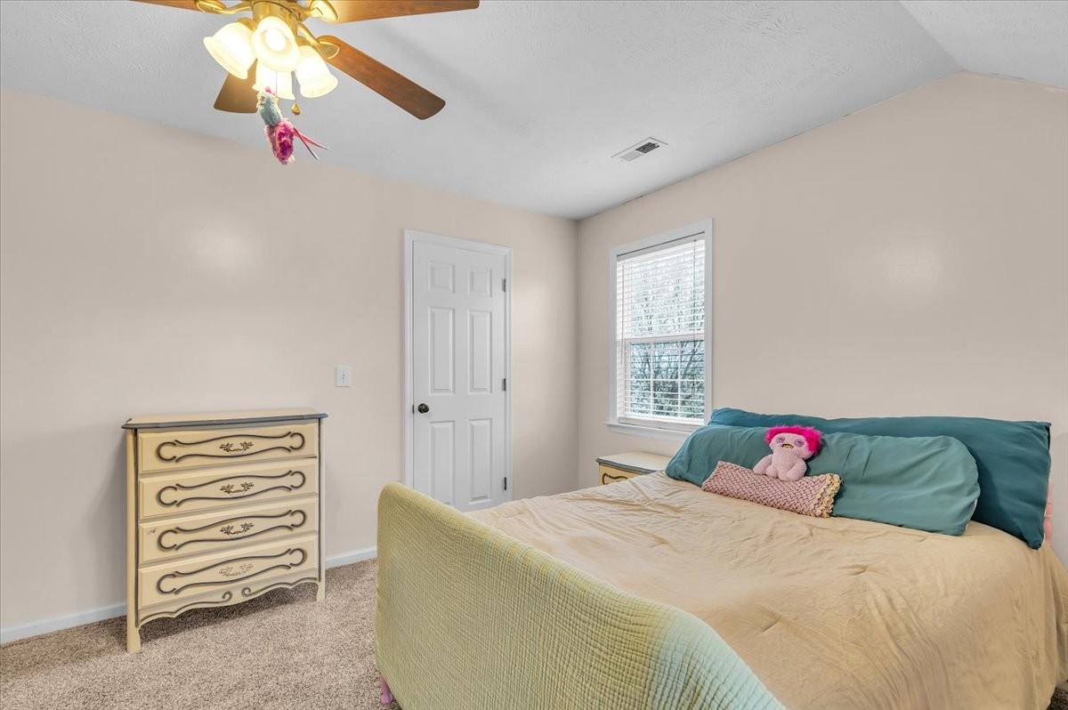 310 Edd Joyce Road Bell Buckle, TN 37020 - Photo 33 of 67 a bedroom with a bed and a chandelier