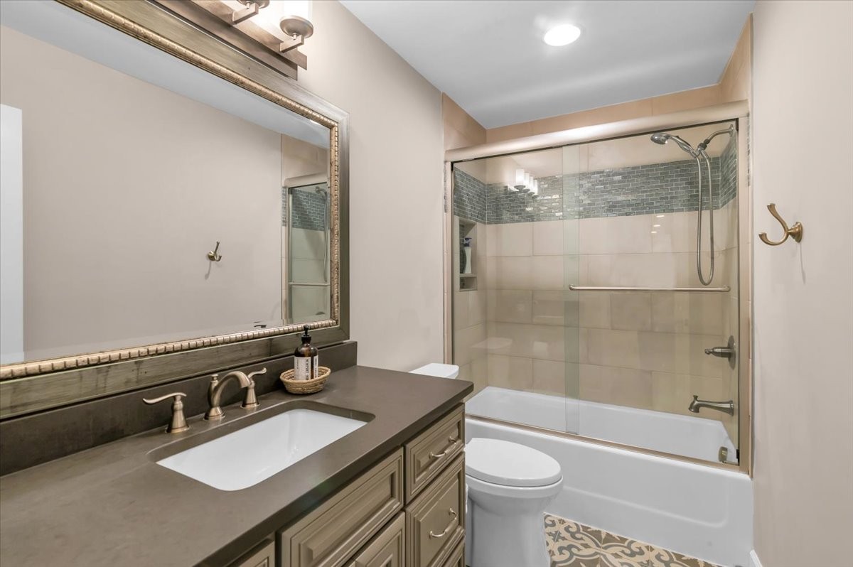 310 Edd Joyce Road Bell Buckle, TN 37020 - Photo 36 of 67 a bathroom with a sink a toilet a mirror and shower