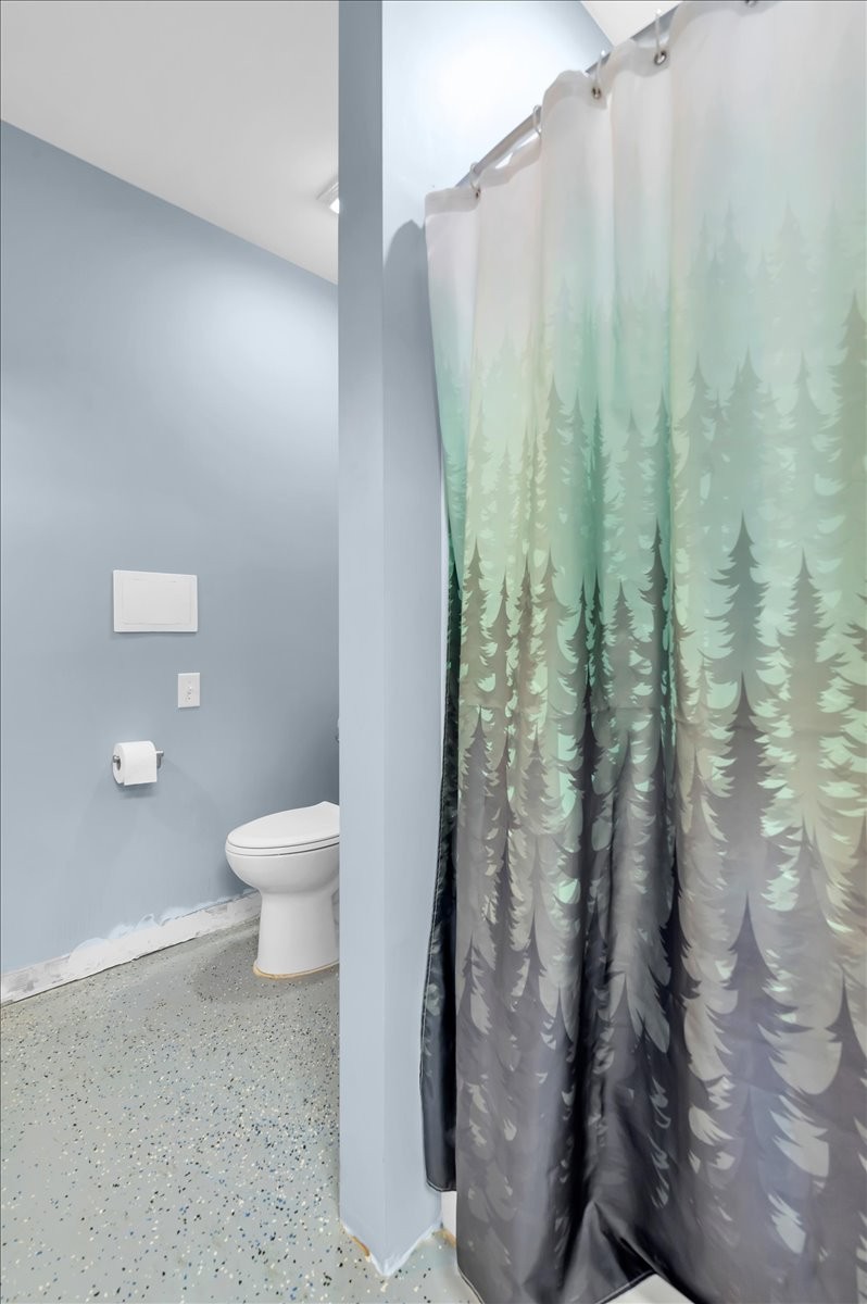 310 Edd Joyce Road Bell Buckle, TN 37020 - Photo 43 of 67 a white toilet sitting next to a shower curtain