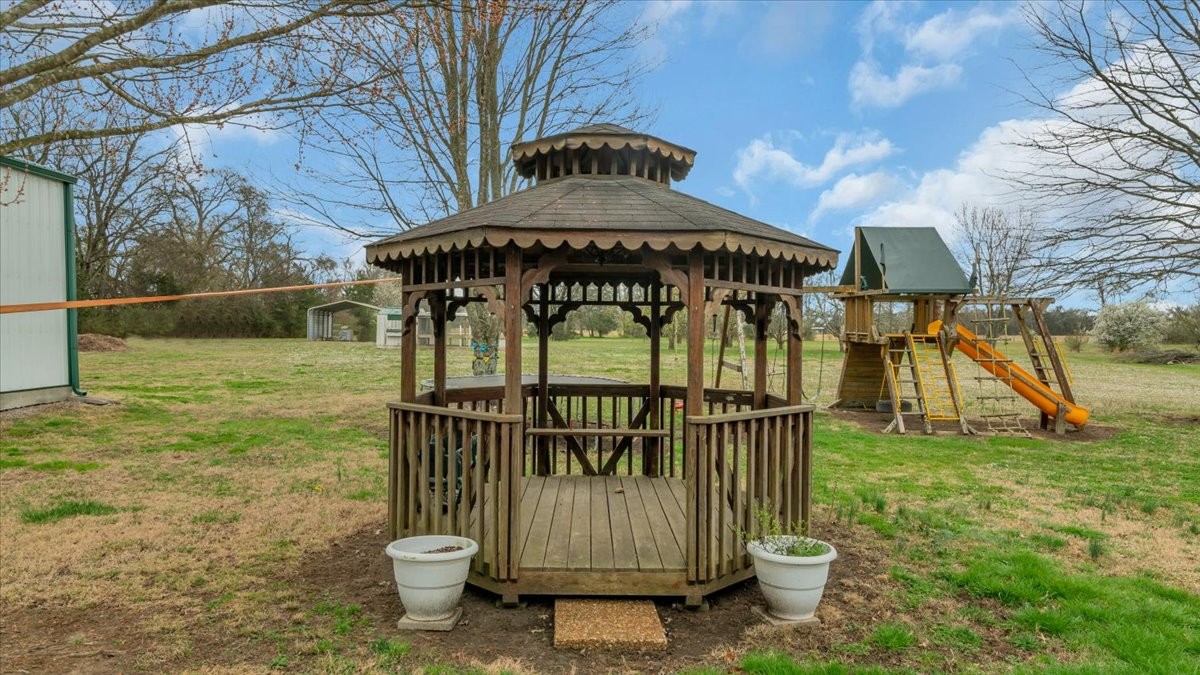310 Edd Joyce Road Bell Buckle, TN 37020 - Photo 51 of 67 a view of a brick house with large trees next to a yard
