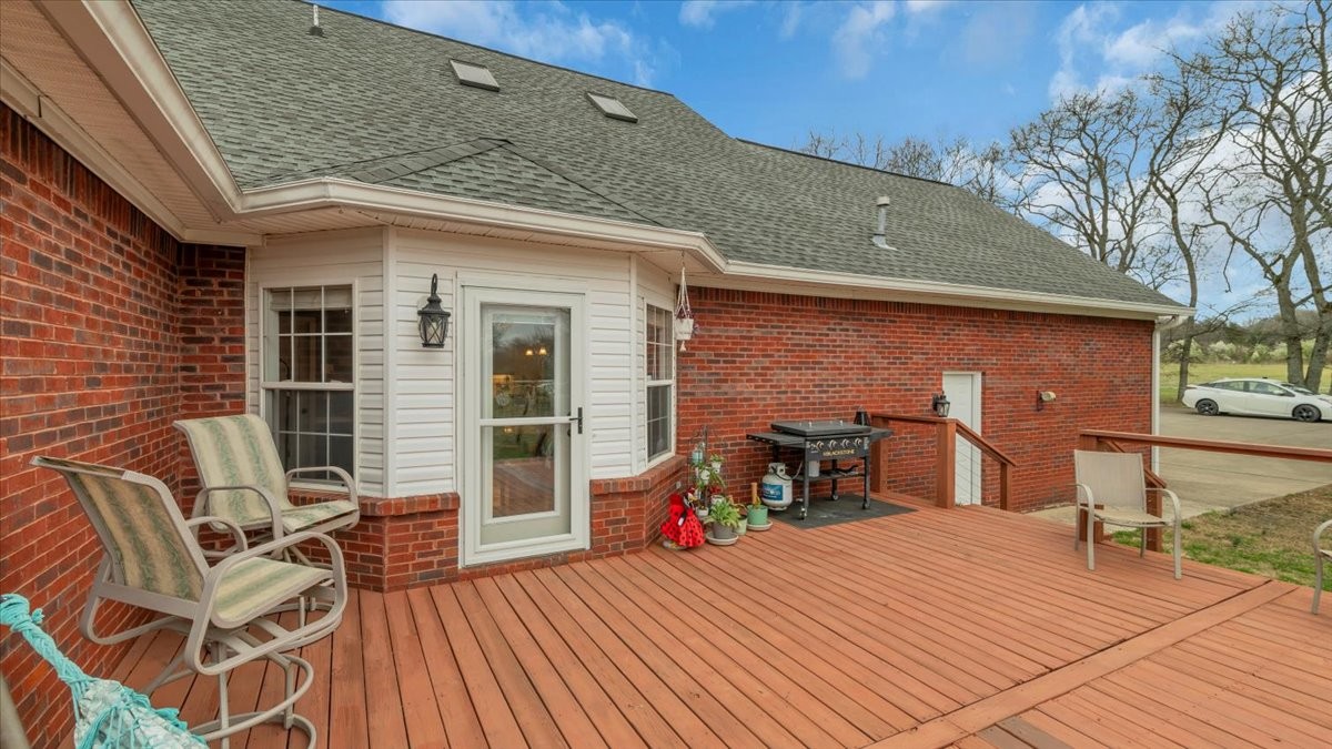 310 Edd Joyce Road Bell Buckle, TN 37020 - Photo 52 of 67 a view of a patio with table and chairs with wooden floor and fence