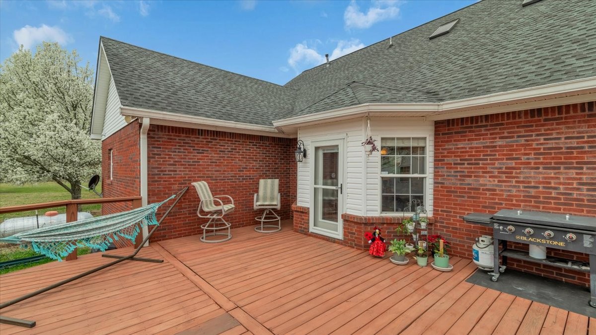 310 Edd Joyce Road Bell Buckle, TN 37020 - Photo 53 of 67 a view of a deck with table and chairs barbeque with wooden floor and fence