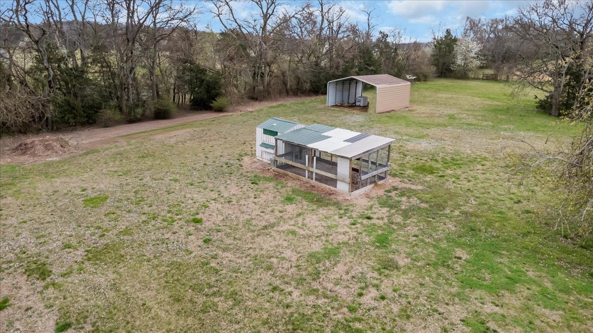310 Edd Joyce Road Bell Buckle, TN 37020 - Photo 59 of 67 a view of a wooden house with a yard and trees