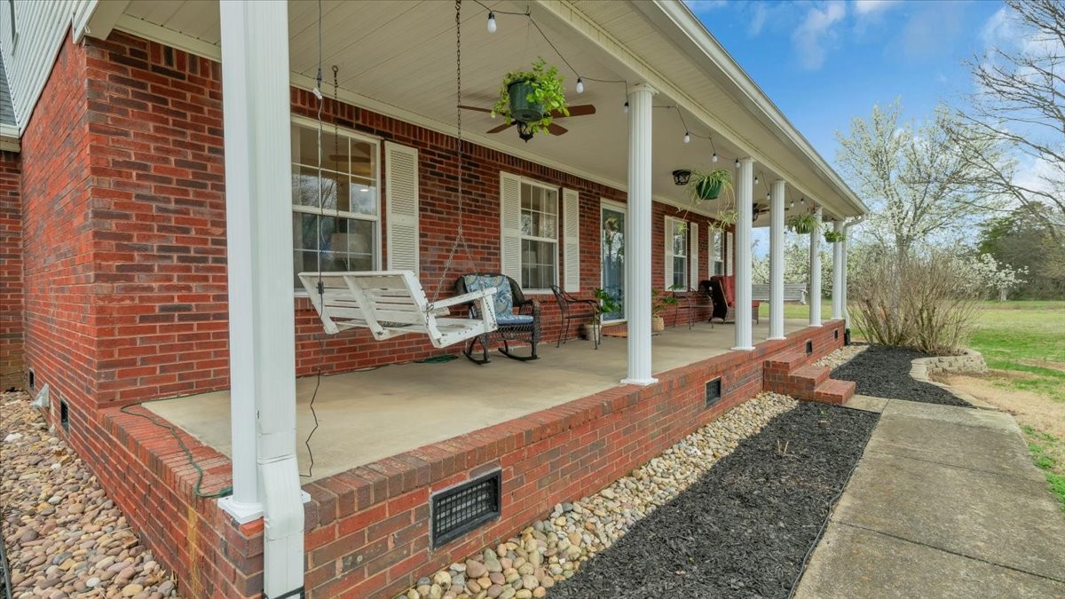 310 Edd Joyce Road Bell Buckle, TN 37020 - Photo 63 of 67 a view of a patio with table and chairs potted plants with wooden floor and fence