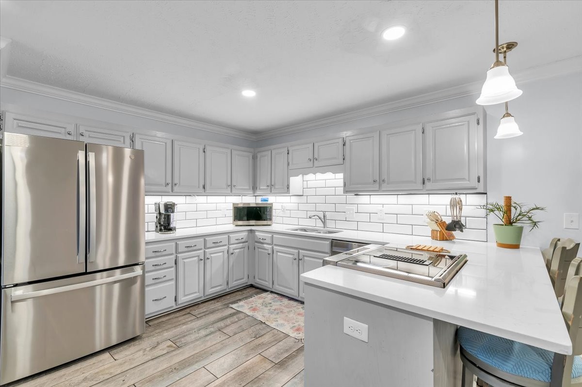 310 Edd Joyce Road Bell Buckle, TN 37020 - Photo 7 of 67 a kitchen with a refrigerator a stove a sink and white cabinets