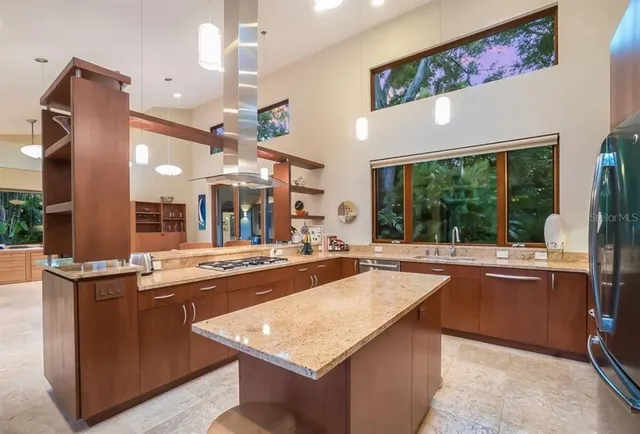 a kitchen with stainless steel appliances granite countertop a sink and a stove
