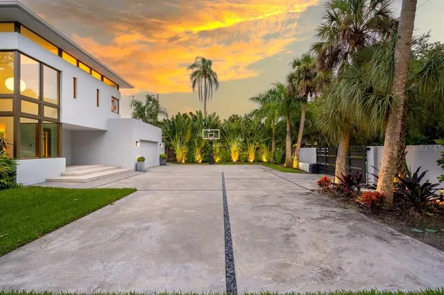 a view of a house with palm trees