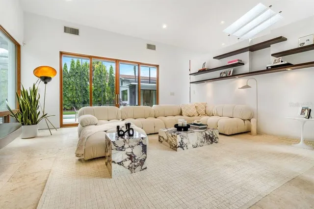 a bedroom with furniture and a large window