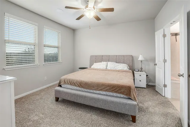 a kitchen with stainless steel appliances kitchen island granite countertop a stove a sink a refrigerator and white cabinets with wooden floor