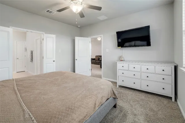 a spacious bedroom with a bed and a window