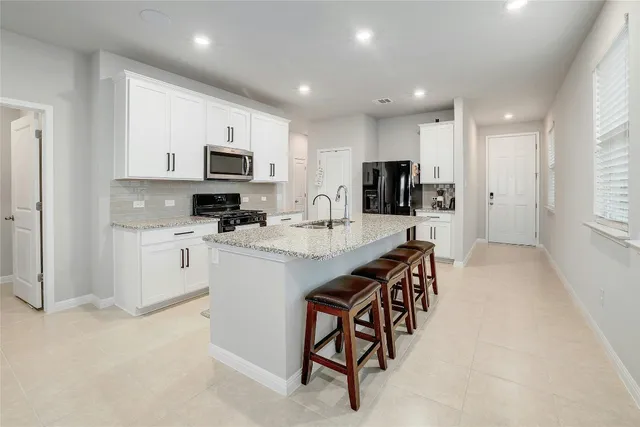 a kitchen with appliances cabinets and a sink