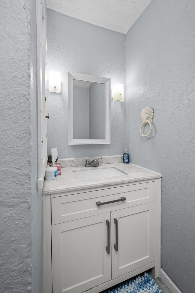 11213 22nd Street Milan, IL 61264 - Photo 18 of 36 a bathroom with a sink and a mirror