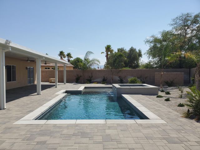 a view of swimming pool with seating space