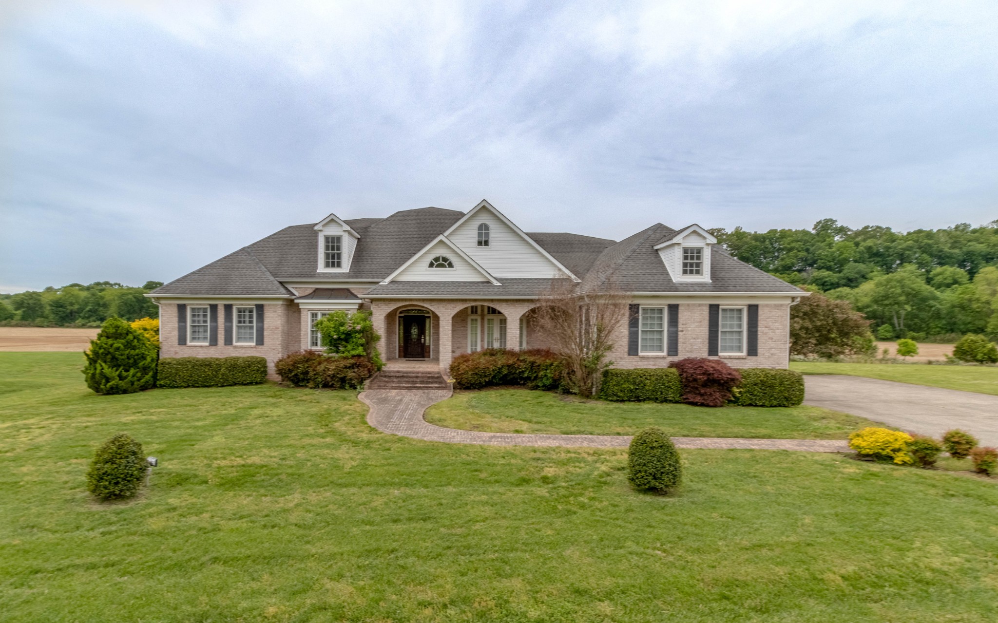 a front view of a house with garden